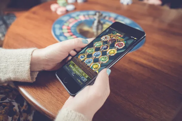 KK333BD Mobile App — Your complete hub for casino and sports A man focused on his laptop with live stats in the background, highlighting the dedicated sports and gaming features of the KK333BD mobile app.
